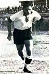 Camille Cordahi wearing a white Lebanese shirt with black shorts
