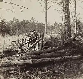 Lt George Chancellor Co E 9th Virginia Cavalry on the Wilderness Battlefield, standing at some Confederate breastworks near Palmer's field on the Orange Turnpike.