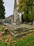 Photograph of the grave of Louisa Cooke, née Hardy, with St Peter's Church, Leckhampton, shown in the background