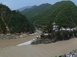 Confluence of Alaknanda (bottom, from right) and Mandakini River (flowing from top - North) at Rudraprayag. Before 17 June 2013, there was a footbridge (jhula) over the Mandakini; this was washed away in the 2013 Uttarakhand floods. The stones at the bottom of the stairs were not there; instead, there was a viewing platform, and a large rock called Narad Shila.