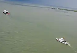 Aerial view of Space Shuttle Explorer exiting Gulf of Mexico