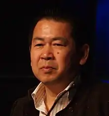 A photograph of Yu Suzuki