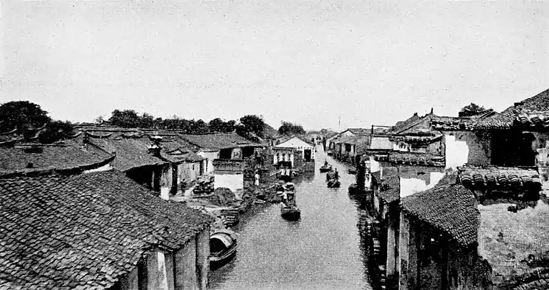 Farmers of forty centuries - Chinese country village lining both sides of a canal.jpg