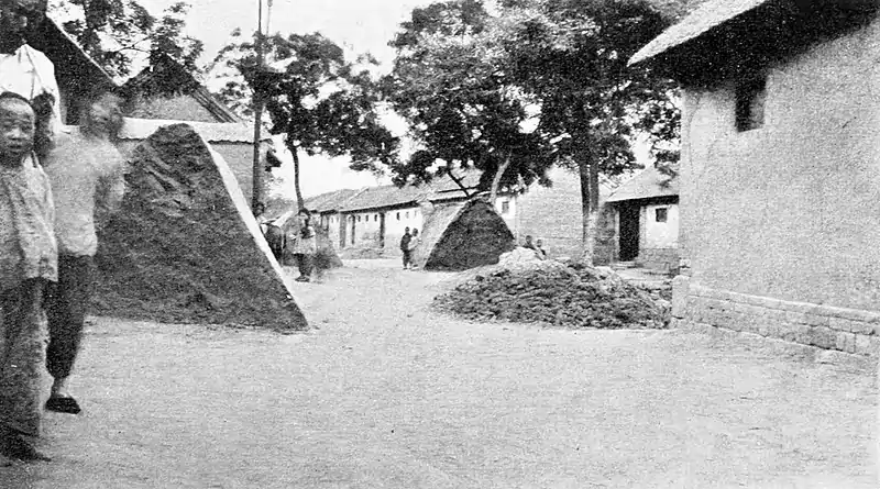 Farmers of forty centuries - Farm village street with stacks of earth and piles of compost, Shantung.jpg